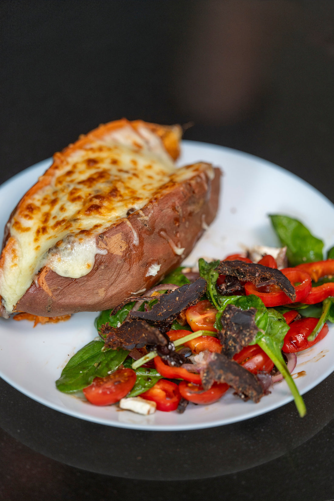 Biltong Powder Loaded Sweet Potato with Melted Cheese and Salad