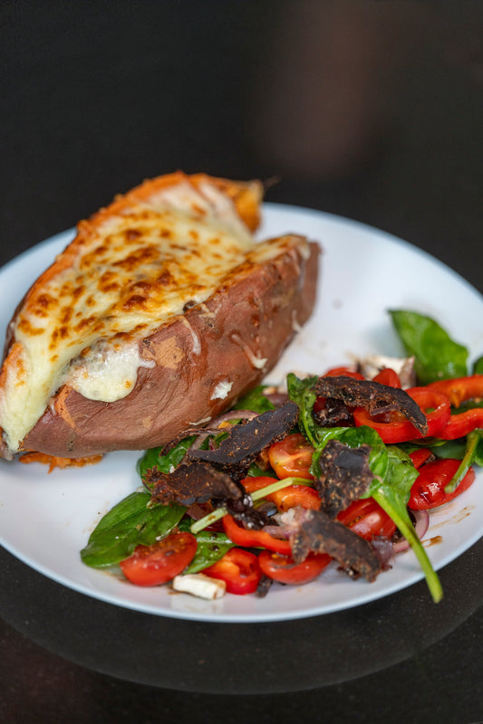 Biltong Powder Loaded Sweet Potato with Melted Cheese and Salad